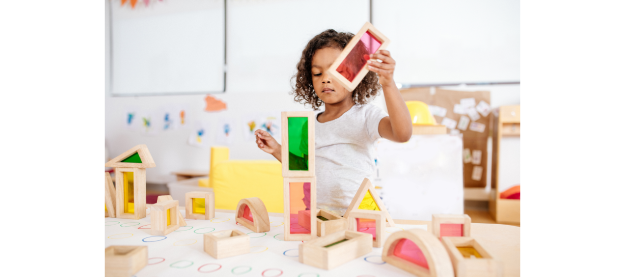 child in classroom playing with building blocks