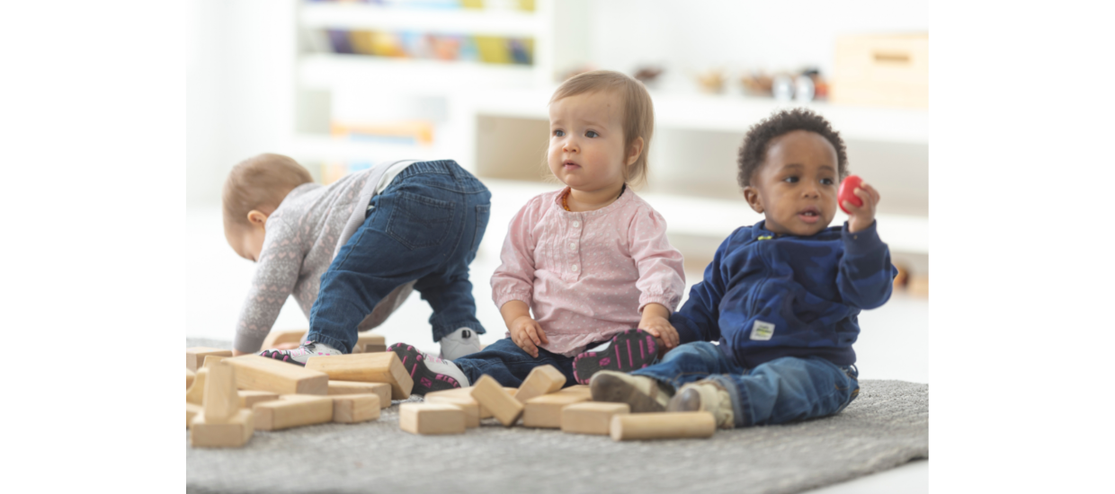 three infants playing