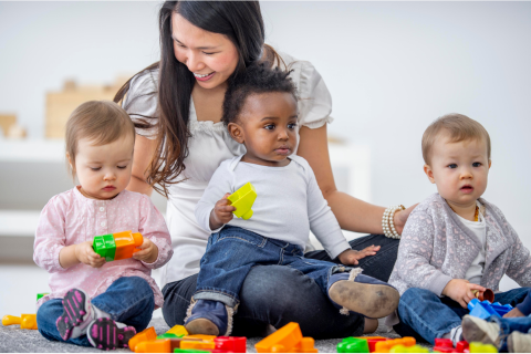 caregiver with three toddlers