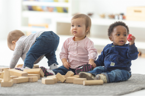 three infants playing